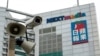 FILE - A security camera is seen in front of the headquarters of Apple Daily and Next Media in Hong Kong.