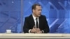 Russian Prime Minister Dmitry Medvedev (C) talks during an interview broadcast on state television in Moscow, Russia, Dec. 9, 2015.