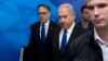 FILE - Israeli Prime Minister Benjamin Netanyahu, center, arrives with Cabinet Secretary Tzachi Braverman for a weekly Cabinet meeting at the prime minister's office in Jerusalem, April 29, 2018. 