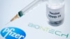 FILE PHOTO- This illustration picture taken on November 23, 2020, shows a bottle reading "Vaccine Covid-19" and a syringe next to the Pfizer and Biontech logo. (Photo by JOEL SAGET/AFP)