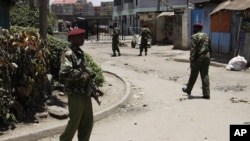 Kenyan police guard the scene following an explosion at a church in Nairobi, Kenya, September 30, 2012.