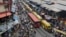 FILE - In this photo taken June 20, 2016, pedestrians shop at a market in Lagos, Nigeria.
