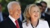 Israel's President Shimon Peres stands with U.S. Secretary of State Hillary Clinton before their meeting in Jerusalem, July 16, 2012