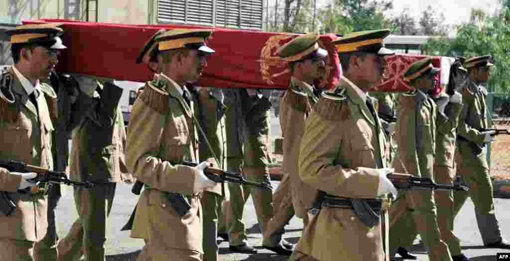 Handout photo released by state-run Syrian Arab News Agency (SANA) shows Syrian security forces carrying the coffins of comrades killed in violence during a funeral at the Tishrin military hospital in Damascus on June 9, 2012. (Photo: AFP/SANA)