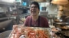 Yuttasak Tanawan, "Chef Tang" prepares King Crab Legs during his live show on social media in Washington,DC. Oct 2020.