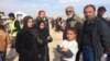The family of Ammar Hazzin (3rd from L) says their flight from New Mosul was delayed after 21 people were executed by IS militants for attempting escape on March 26, 2017 in Hammam Alil, Iraq. (H.Murdock/VOA)