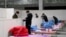 Workers set up infrastructure at the Wuhan International Conference and Exhibition Center to convert it into a makeshift hospital to receive patients infected with the new coronavirus, in Wuhan, Hubei province, China February 4, 2020. Picture taken…