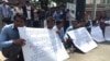 A group of former bus drivers of Capitol Tours Cambodia company​ on Monday, February 8, 2016, held banners showing the demand for justice for Norn Vanna, a former bus driver of Capitol Tours Cambodia company and Ros Siphay, a member of the Cambodian Labor Confederation who were arrested by authorities in Phnom Penh's Prampi Makara district on Saturday, February 6, 2016 and sent the Phnom Penh Municipal Court on Monday, February 8. They both were detained by the court on Monday on charges of “intentional violence, opposing public officials, and obstruction to public traffic.” (Hul Reaksmey/VOA Khmer) 