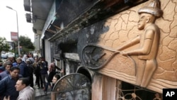 Egyptian investigators check the scene of a nightclub attack in Cairo, Egypt, Dec. 4, 2015.