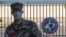 In this Feb. 21, 2020, photo, a South Korean marine wearing a mask stands in front of the Navy Base after a soldier of the unit was confirmed to have been infected with the coronavirus on Jeju Island, South Korea. The U.S. and South Korean…