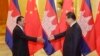 Cambodian Prime Minister Hun Sen, left, shakes hands with China's President Xi Jinping before a meeting at the Great Hall of the People in Beijing Friday, Nov. 7, 2014. (AP Photo/Jason Lee, Pool)
