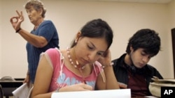 FILE - Students at the University of Texas-Southmost College work on a writing assignment in an English as a Second Language class in 2006. (AP Photo/Brad Doherty)