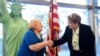 New US citizen Tamam Shanazarian, left, shakes hands with Nancy Alby, field director of USCIS Los Angeles, during a naturalization ceremony ahead of World Refugee Day by the US Citizenship and Immigration Services on June 17, 2021 in Los Angeles.