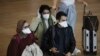 Passengers wearing masks arrive at the Ben Gurion Airport near Tel Aviv, Israel, March 10, 2020. Israel will quarantine anyone arriving from overseas for 14 days, a decision coming barely a month before Easter and Passover. 