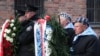 Survivors carry a wreath at the Auschwitz Nazi death camp in Oswiecim, Poland, Jan. 27, 2020. 